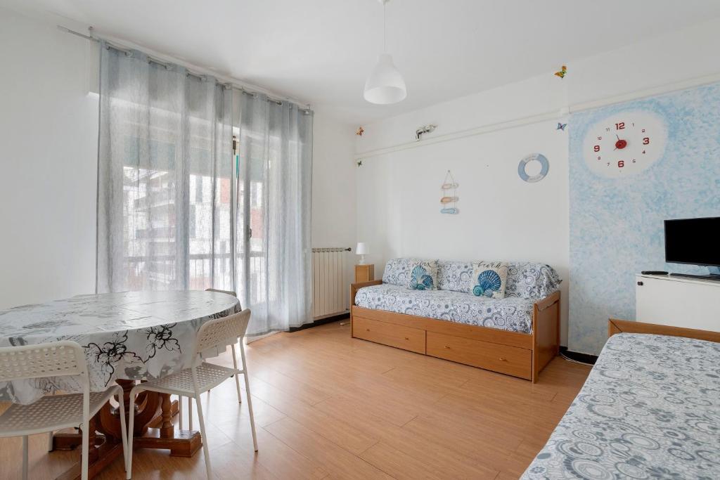 a bedroom with a bed and a table and chairs at Porta Delle 5 Terre in Levanto
