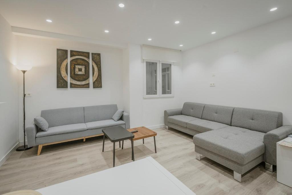 a living room with two couches and a table at Mónaco in Valladolid