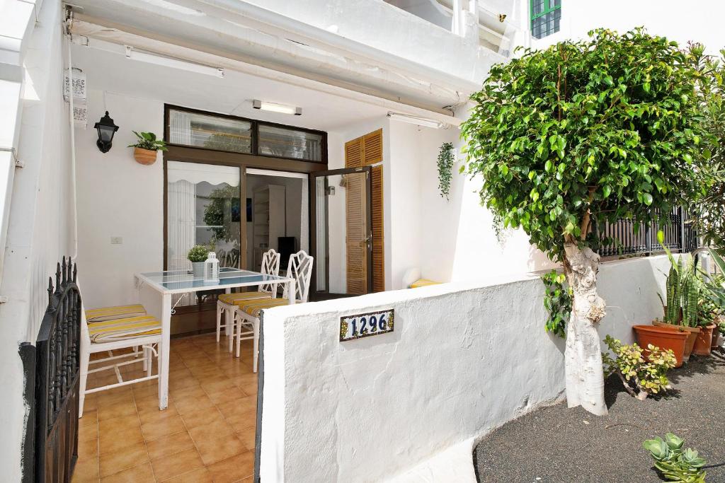 a dining room with a table and a tree at Casa Carmen in Puerto del Carmen