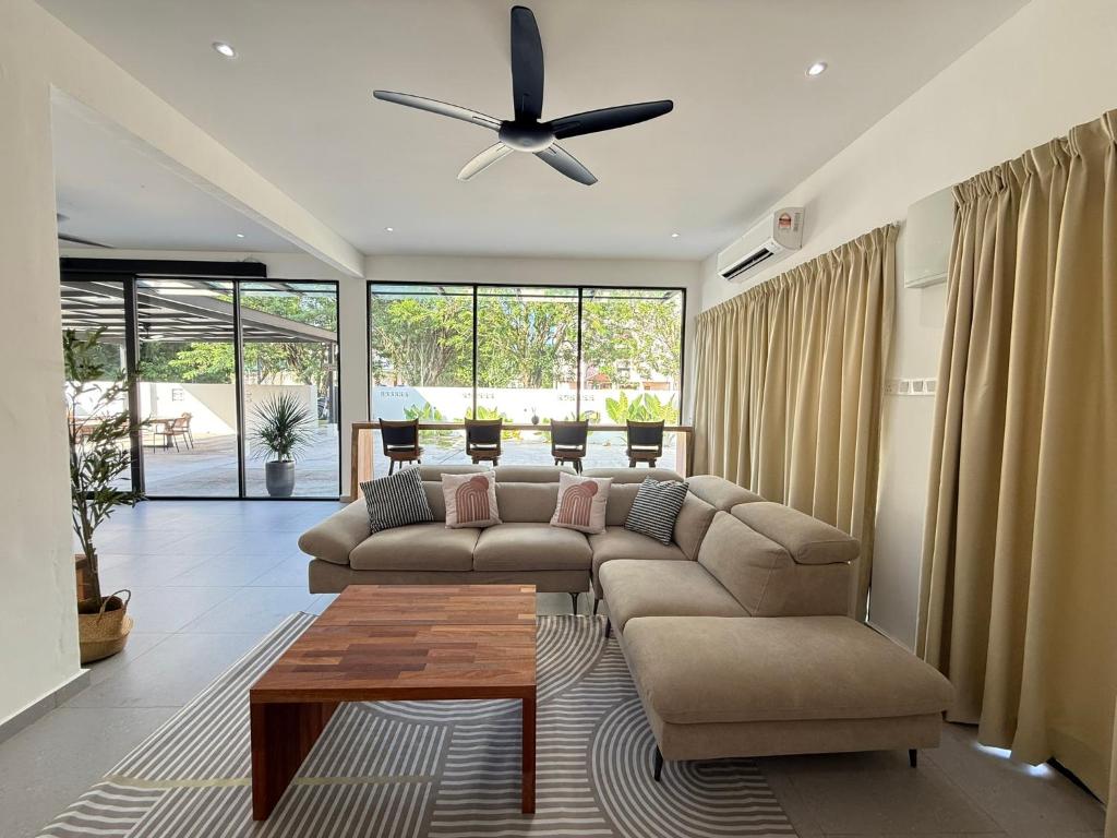 a living room with a couch and a ceiling fan at Mujito4 16PAX 4BR 1 Min To ECM KCM, BBQ PIT, PS4, Netflix in Kuantan