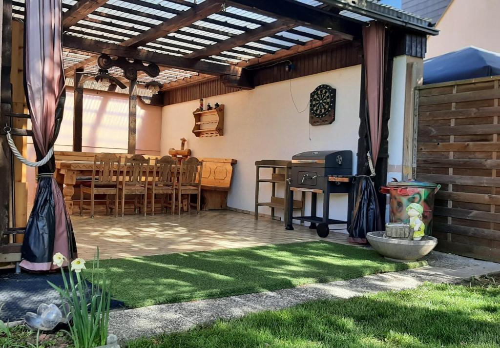 a patio with a wooden pergola and a table at Haus am Ring in Spielberg