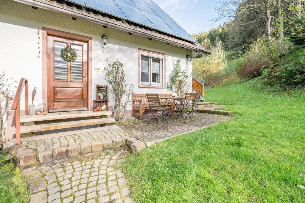 a white house with a wooden door and a patio at Dorerhof Prechtal in Elzach