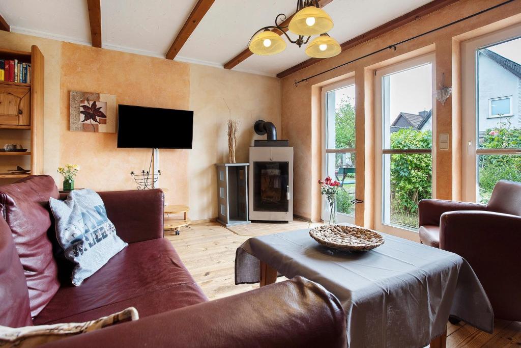 a living room with a couch and a table at Ferienhaus Sundperle in Stralsund