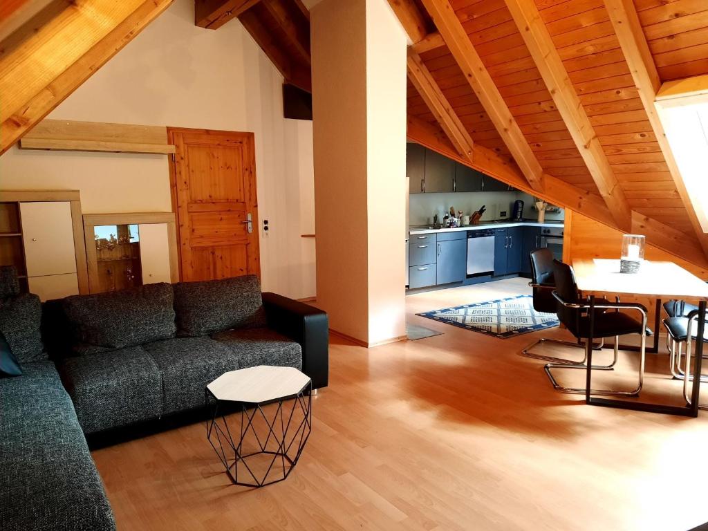a living room with a couch and a table at Ferienwohnung Schwarzwaldfeder in Todtnau