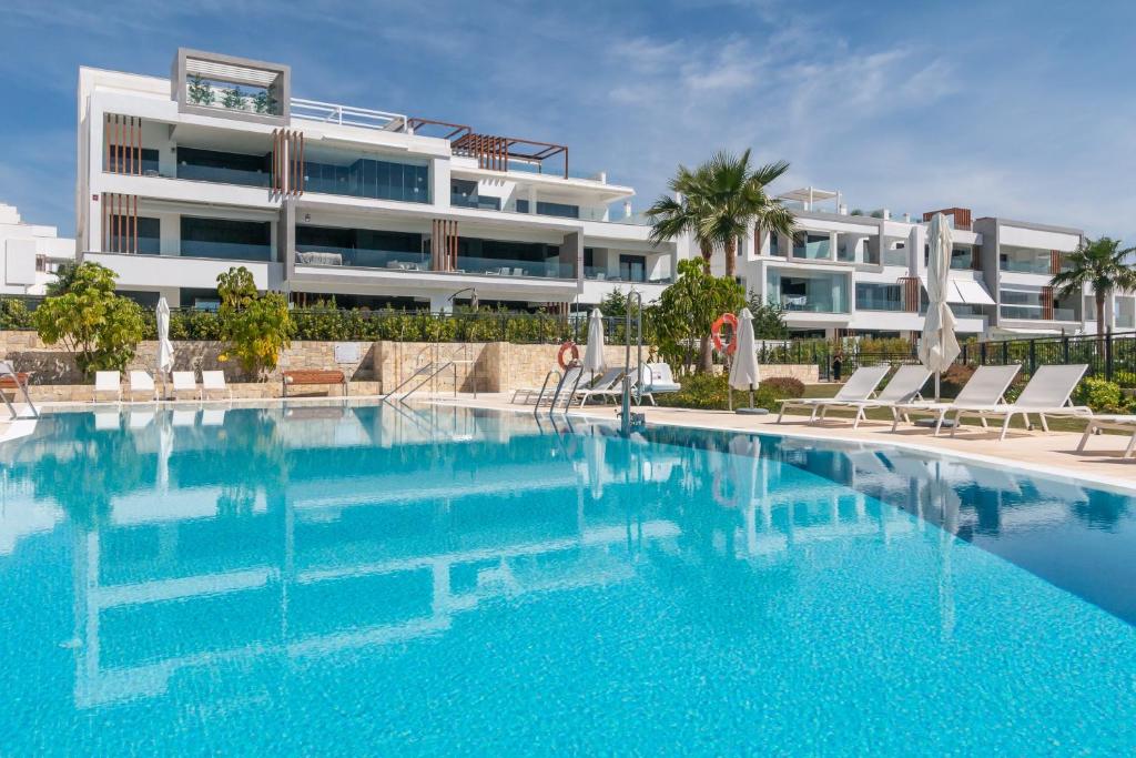 a large swimming pool in front of a building at Ground floor 2bed Miradores del Sol in Estepona