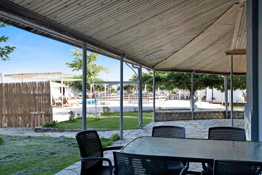 a patio with a table and chairs under a canopy at Iguana studio 11 in Preveza