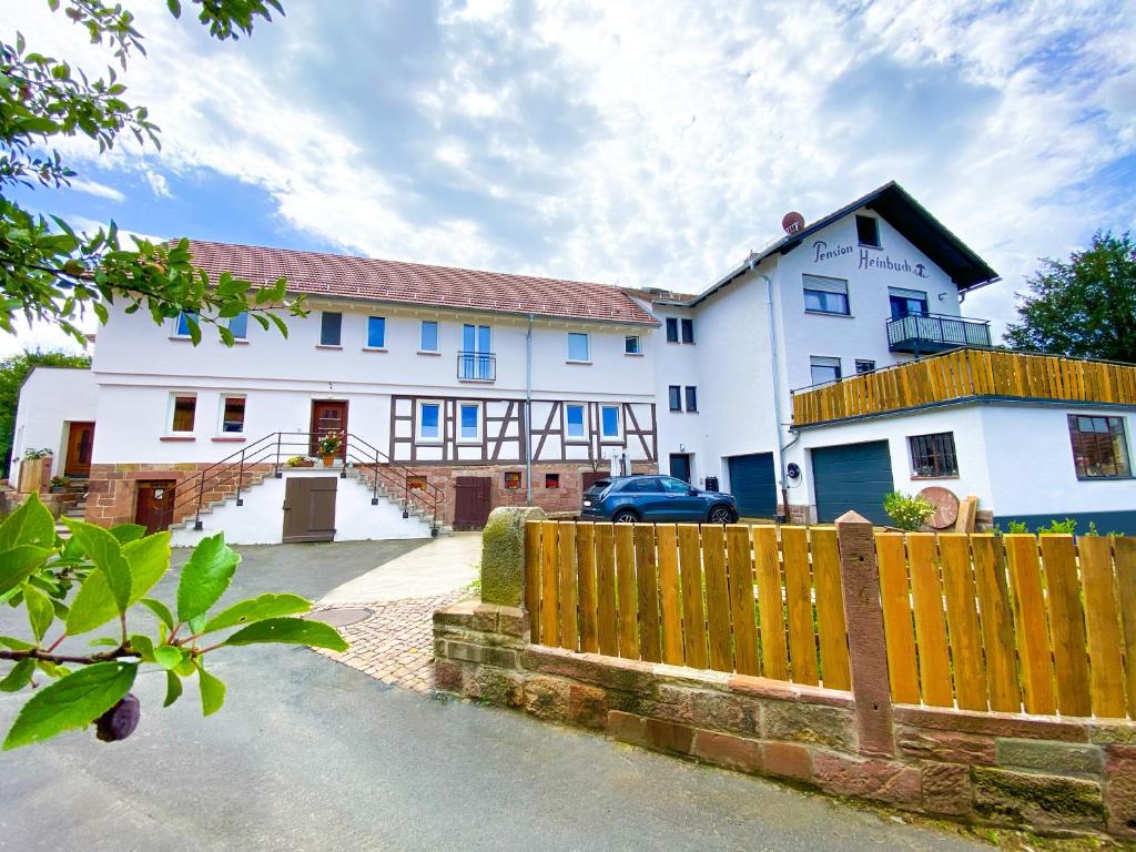 a white house with a fence in front of it at Sand 68 in Steinau an der Straße