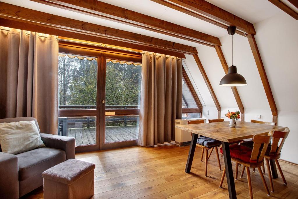 a living room with a table and a couch at Ferienhaus Amrhein in Siegsdorf