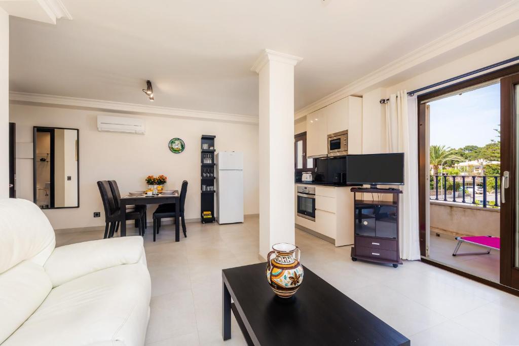 a living room with a white couch and a table at Gala in Cala Ratjada