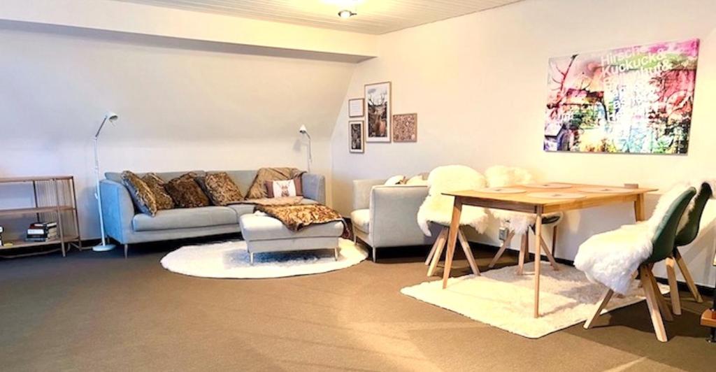a living room with a couch and a table at Fewo Tannenduft - Freudenstadt in Freudenstadt