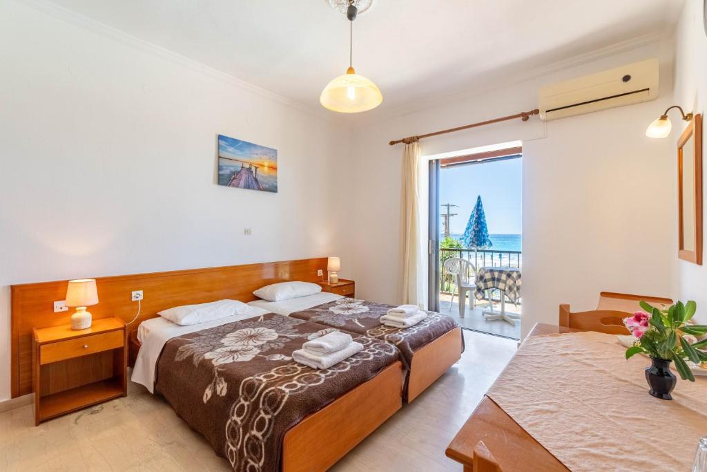 a bedroom with a bed and a view of the ocean at Mires House Front Studio 2 in Agios Gordios