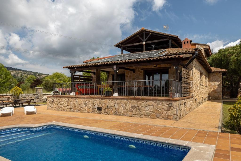 a house with a swimming pool and a building at Sierra Norte Madrid in El Berrueco