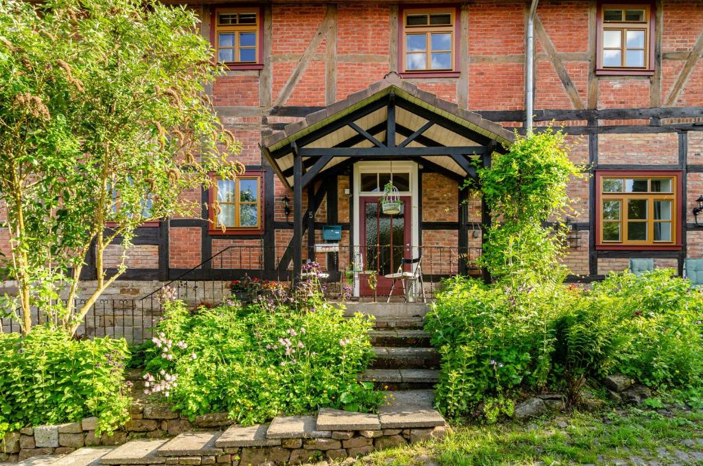 a brick house with stairs leading to the front door at Villa Gottstreu in Gottstreu