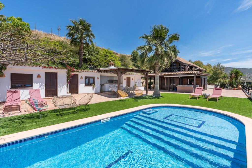 an image of a swimming pool in front of a house at Finca La Haima in Motril