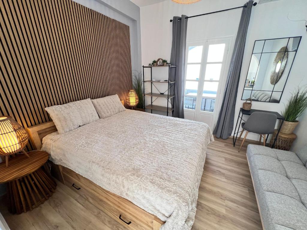 a bedroom with a large bed and a couch at aeolian blu 5 in Parikia