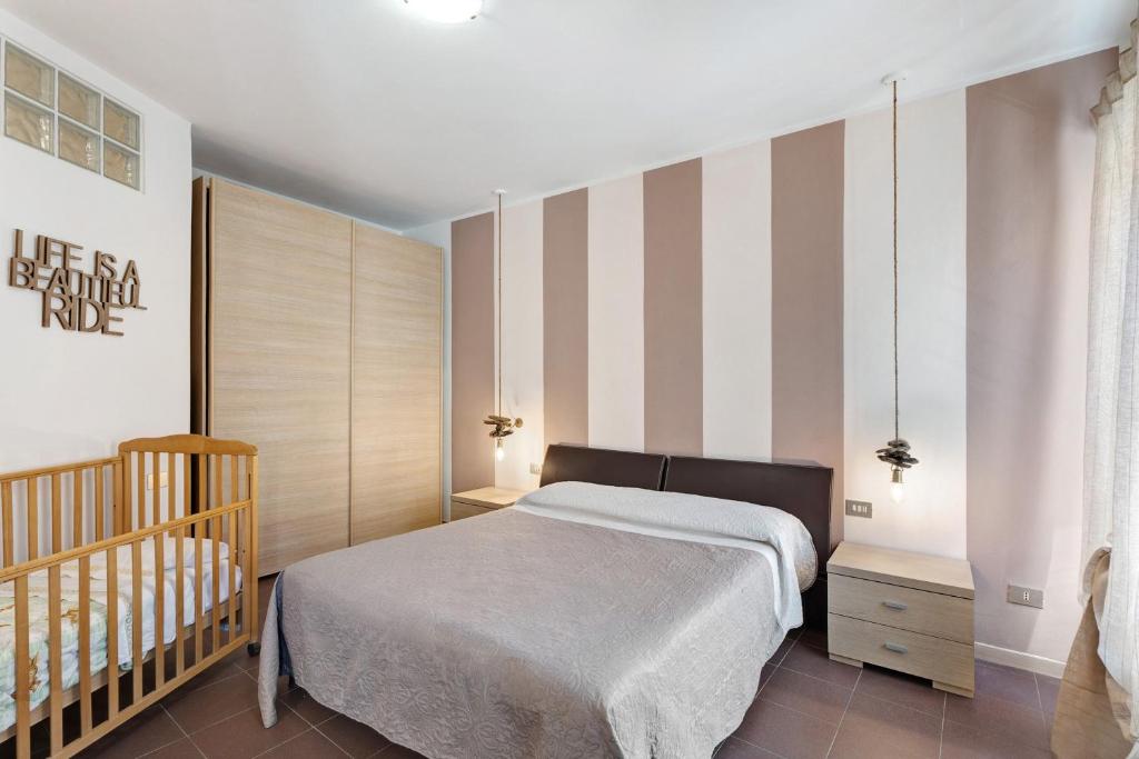 a bedroom with a bed and a crib at Vecchia Scala in Germignaga