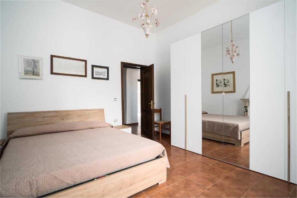 a bedroom with a bed and a mirror at Casa Picchereddu in Orosei