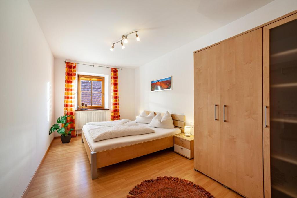 a bedroom with a bed and a large wooden cabinet at Ferienwohnung Jonagold Schnalserhof in Laces
