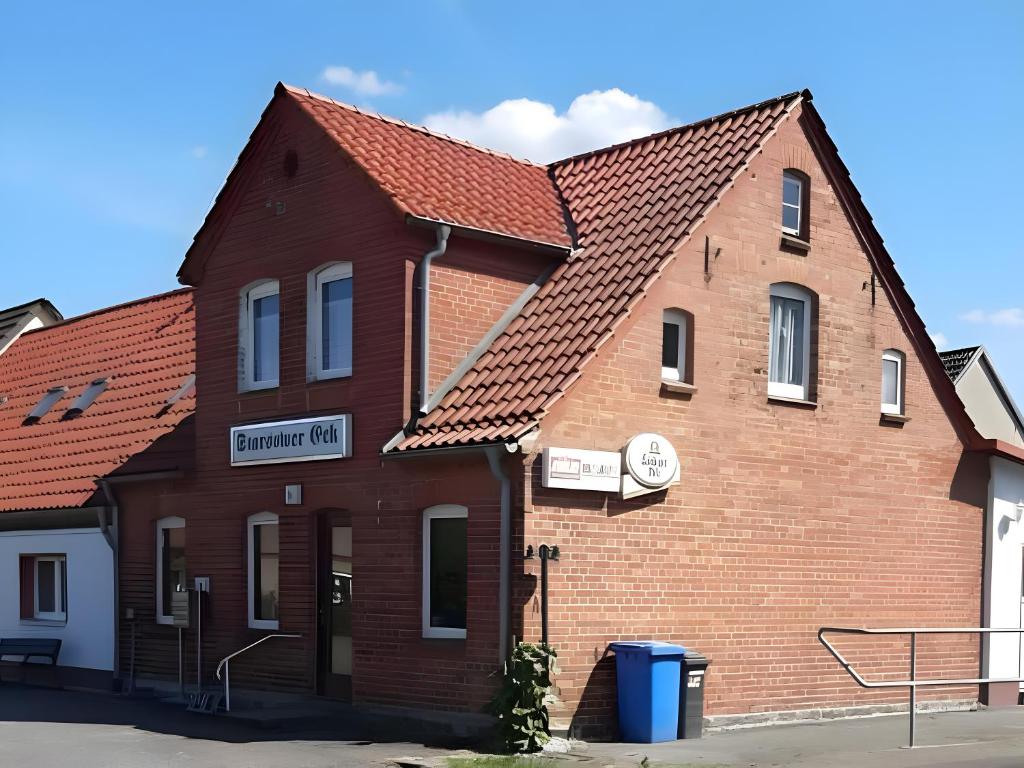 a large brick building with a red roof at Ferienwohnung Max und Moritz in Mirow