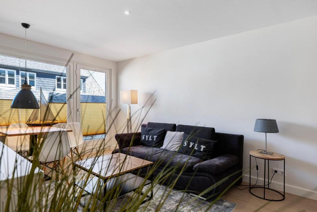 a living room with a couch and a window at Wohnung Früger in Westerland