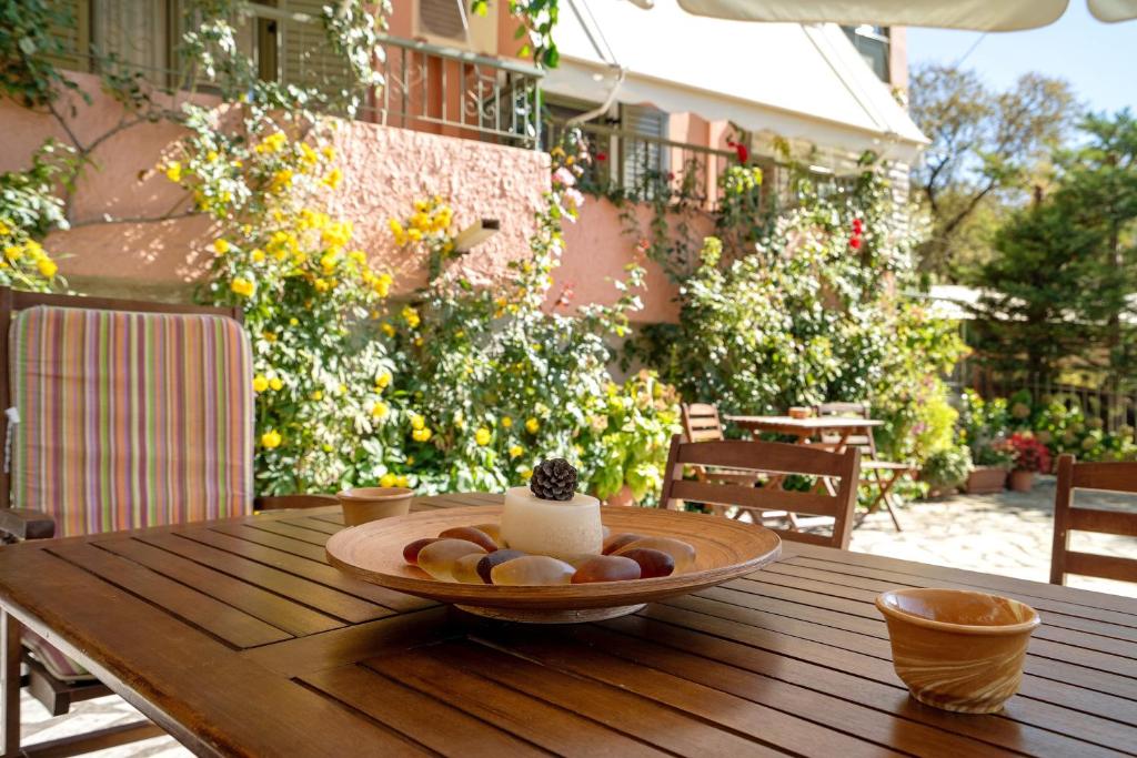 a plate of food on a wooden table on a patio at Nontas Home 22 in Kalamitsi