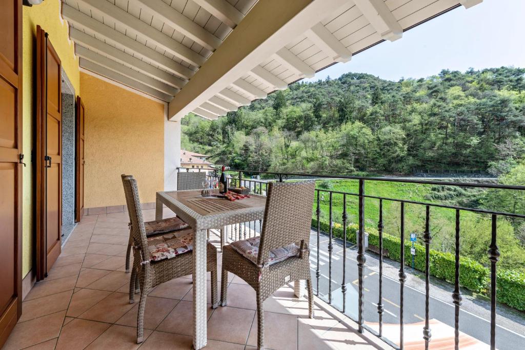 a patio with a table and chairs on a balcony at Residence Tatiana B2 in Tremosine Sul Garda