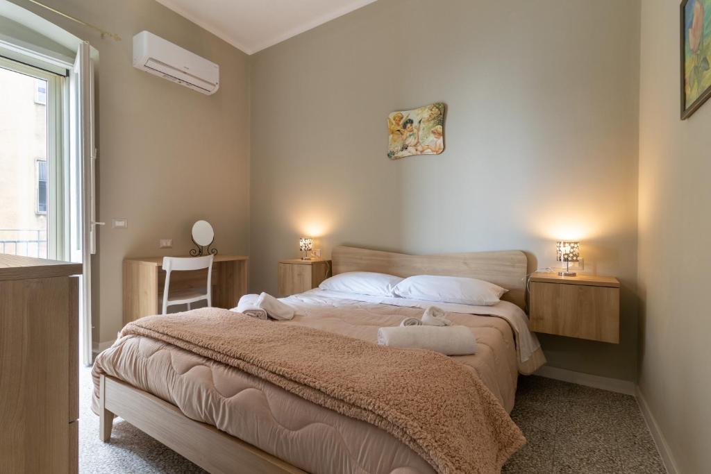 a bedroom with a large bed and two night stands at Dormiamoci Sù in Mottola
