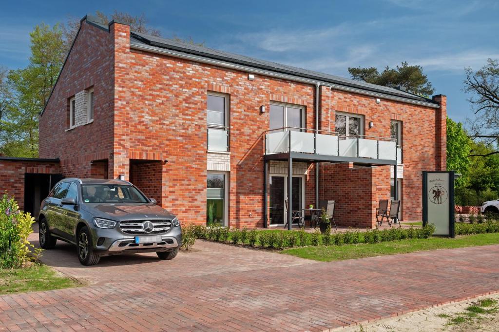 a car parked in front of a brick building at Gästehaus Anna in Suhle