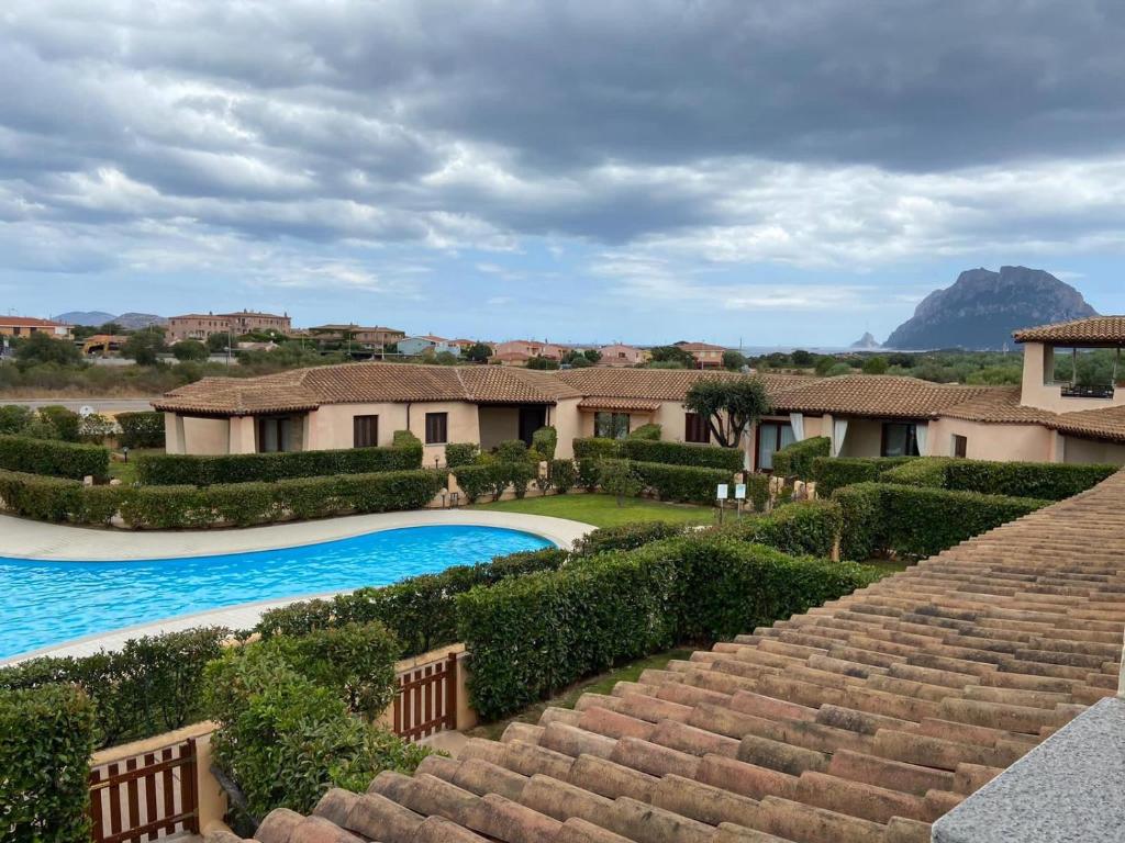 a villa with a swimming pool and some stairs at Casa Vacanze Cocco in Porto San Paolo