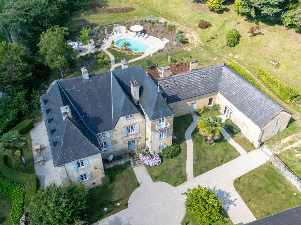 an aerial view of a house with a swimming pool at Château des Salettes in Anoye