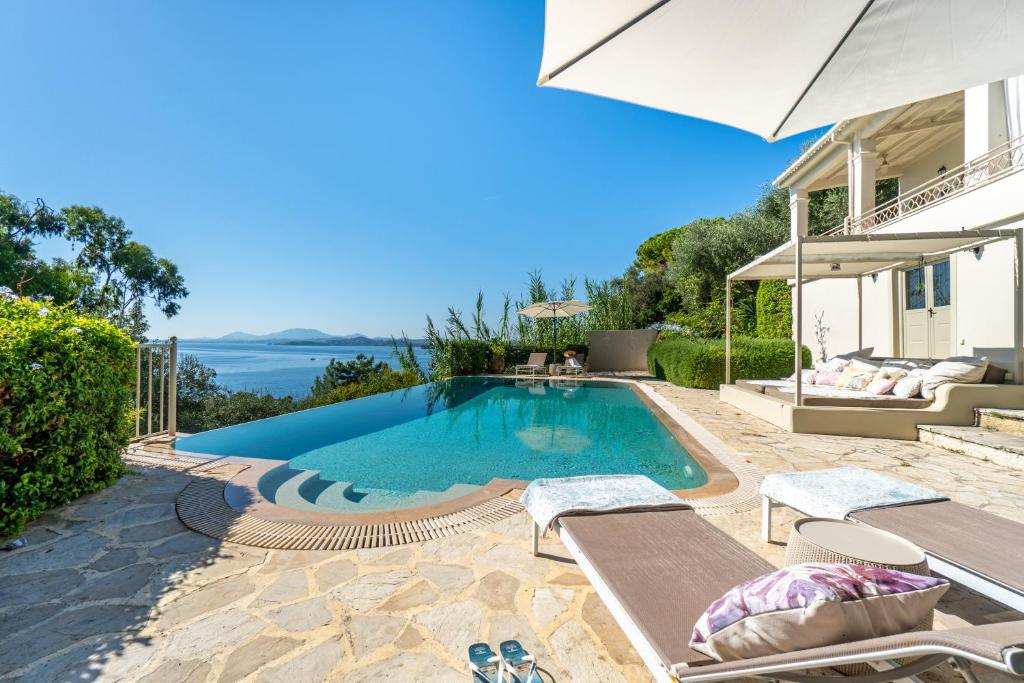a swimming pool in the backyard of a house at Villa Armonia in Pyrgi