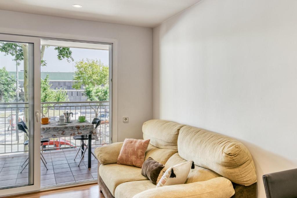 a living room with a couch and a balcony at Olga in Platja d'Aro