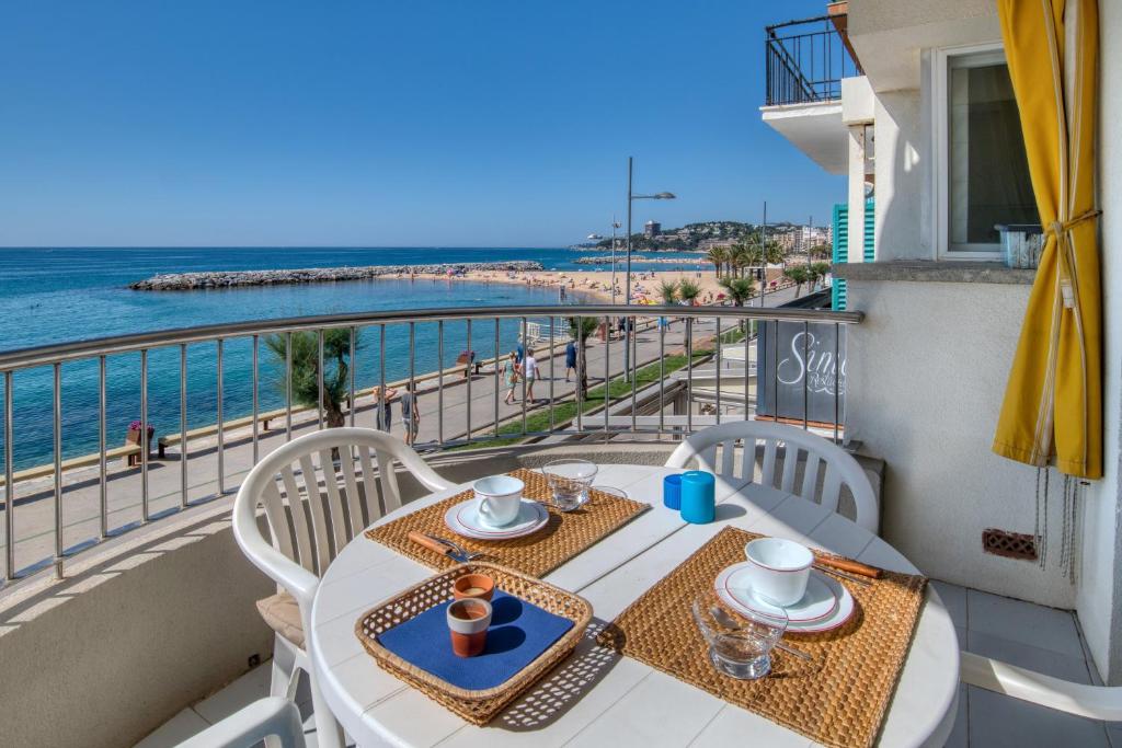 a balcony with a table and chairs and the ocean at Apartamento en 1 línea mar in Sant Antoni de Calonge