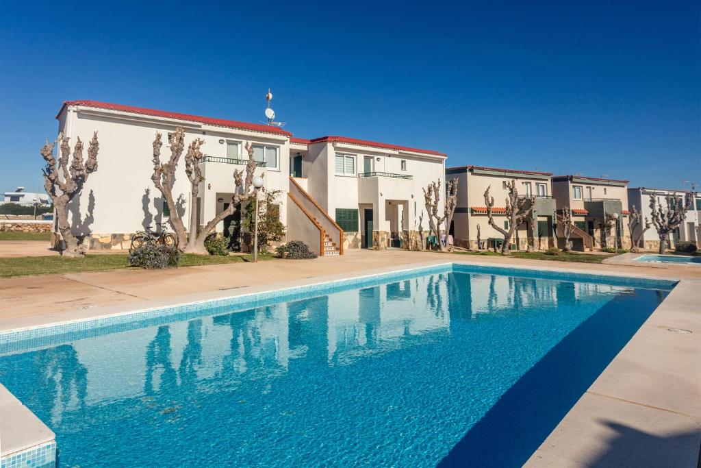 a swimming pool in front of a building at Cala en Forcat in Menorca