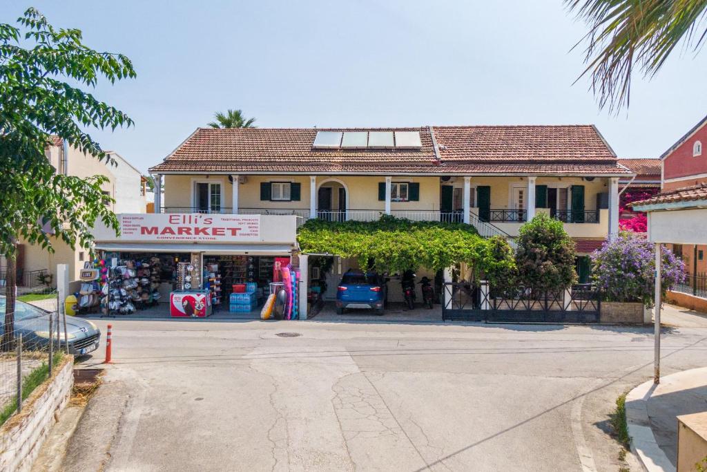 a building with a market in front of a store at Eli Guesthouse in Kavos