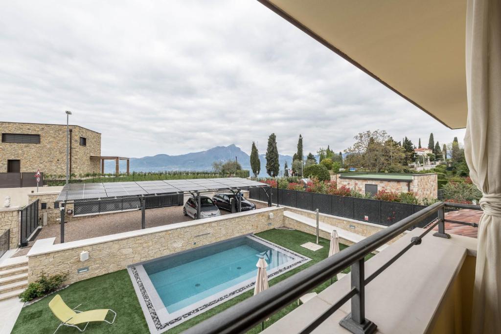 a view from the balcony of a house with a swimming pool at Passioncasa in Torri del Benaco