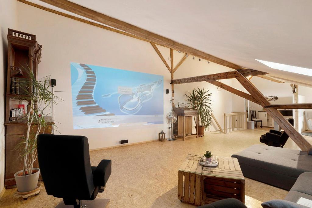 a living room with a presentation on a screen at Loft Sven in Baden-Baden