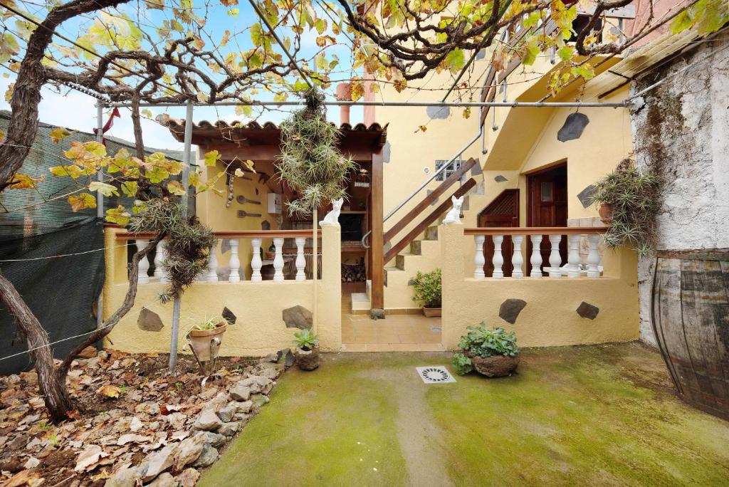 a house with a staircase and a yard at El Lagar in Los Silos
