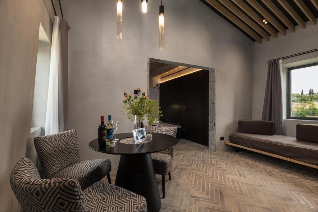 a living room with a table and chairs and a couch at Suite Fattoressa in San Gimignano