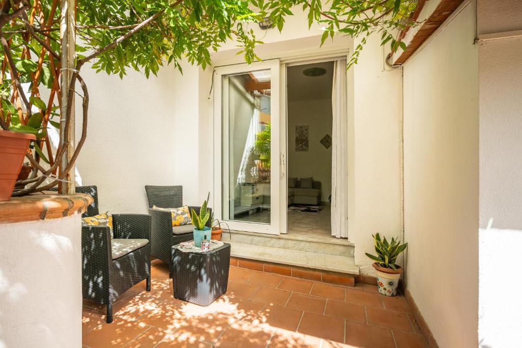 a patio with a couch and a table at In casetta in Cagliari