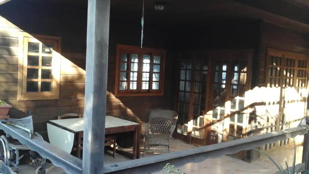 a porch of a house with a table and chairs at Chalet Rural Marian in Santa Maria de Guia de Gran Canaria