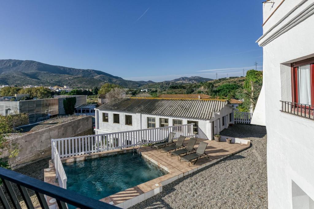 a house with a swimming pool and a balcony at Ca la Yaya in Llança