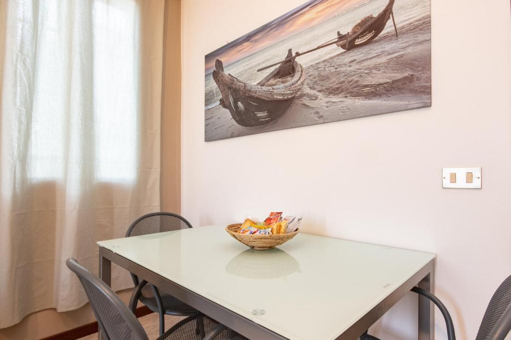a dining room table with a bowl of fruit on it at Il grappolo monolocale in Sirmione
