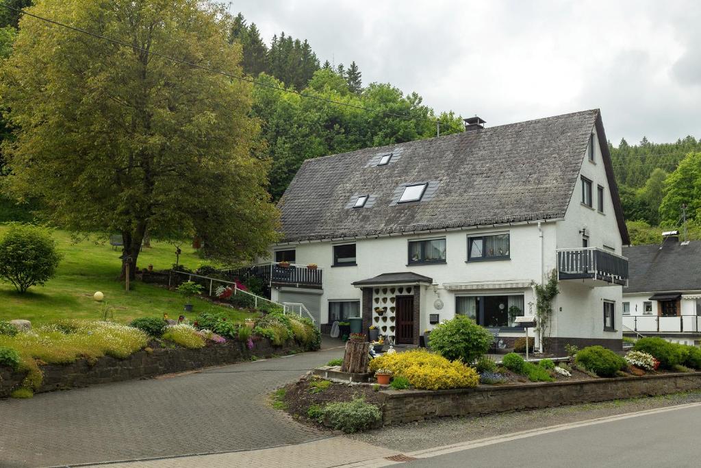 a white house with a garden in front of it at Fewo Schober in Kirchhundem