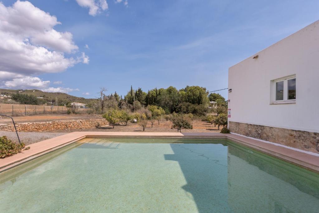a pool of water in front of a building at Finca Can Paci in Santa Eularia des Riu