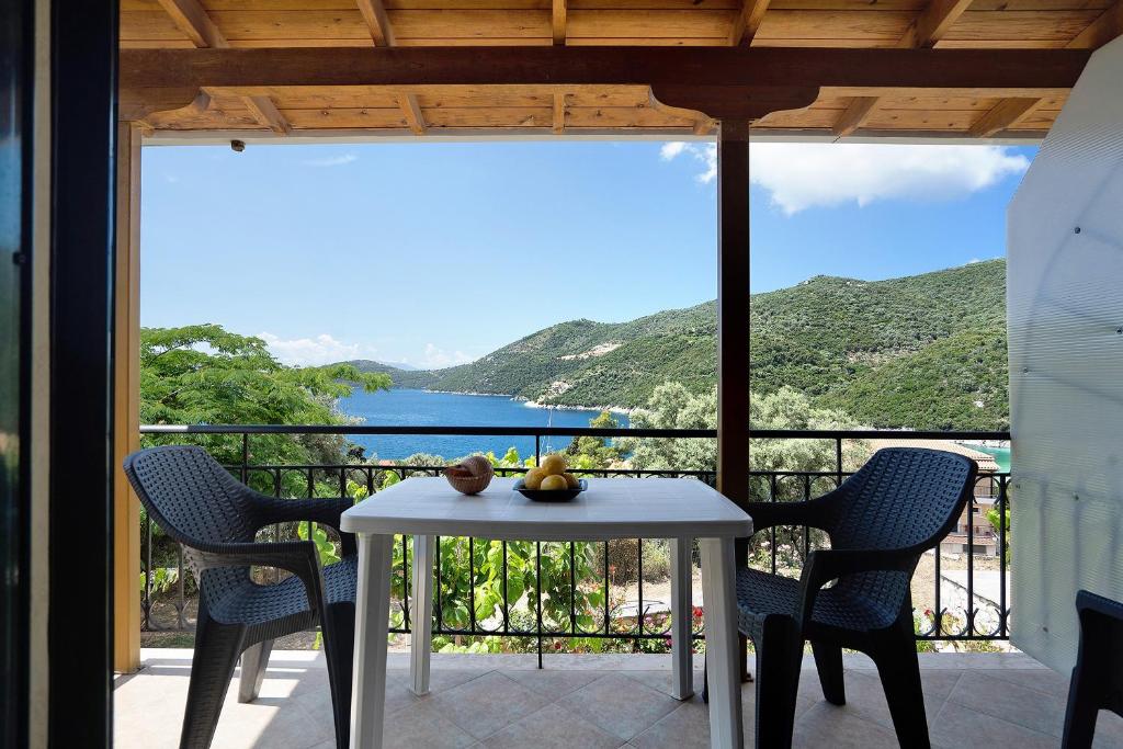 a table and chairs on a balcony with a view at Vardia studio B in Mikros Gialos