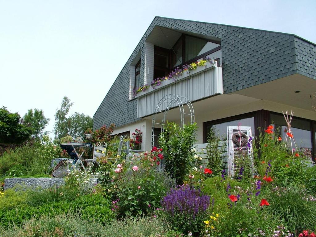 a house with a flower garden in front of it at Haus Müller in Böhringen