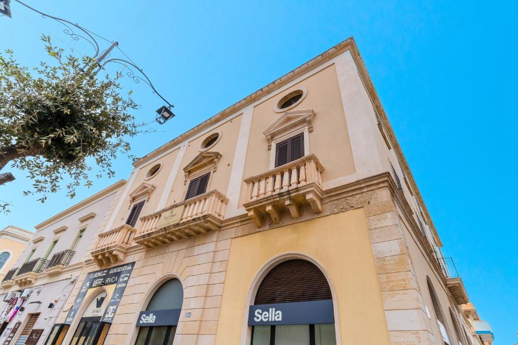 a building with a balcony on the side of it at Palazzo Mongiò in Gallipoli