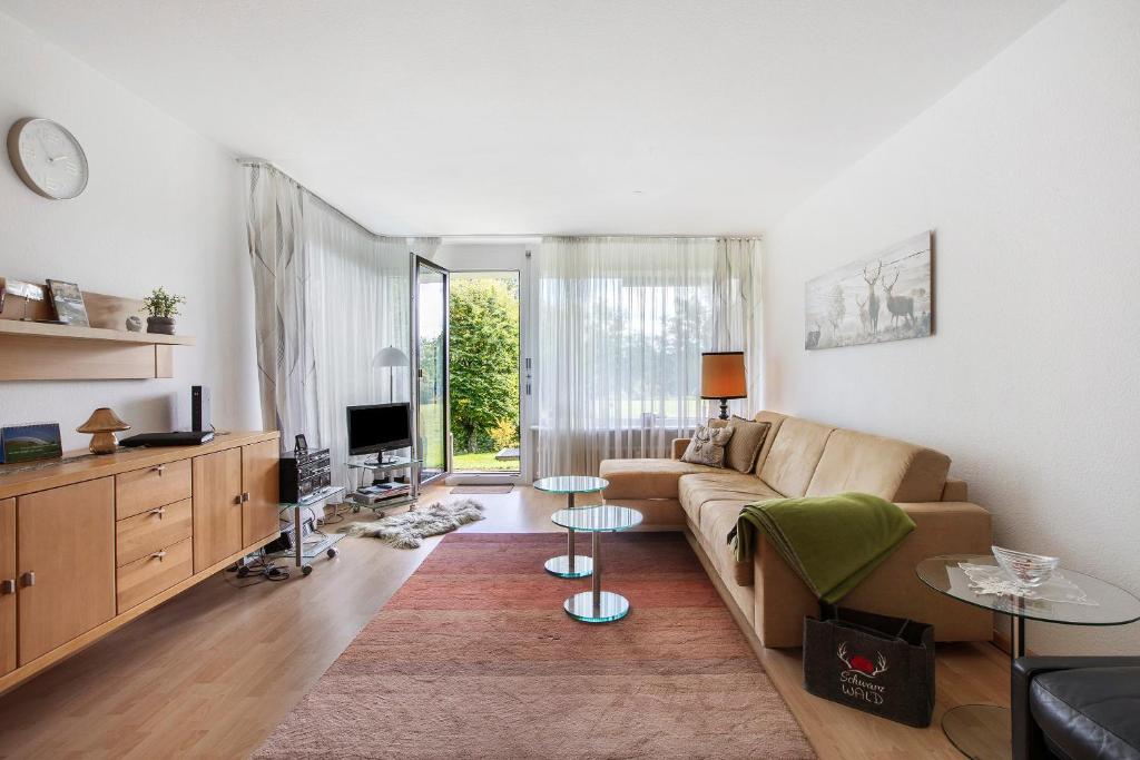 a living room with a couch and a tv at Fewo Waldfee in Höchenschwand