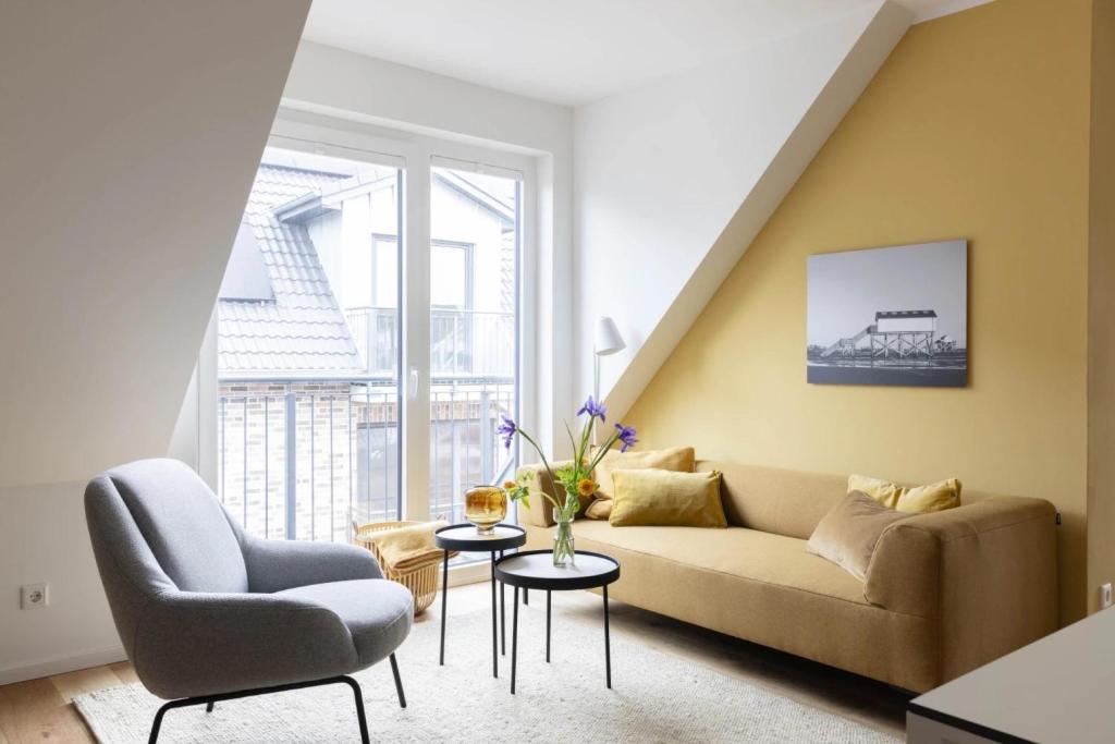 a living room with a couch and a chair at Strandroggen in Böhl